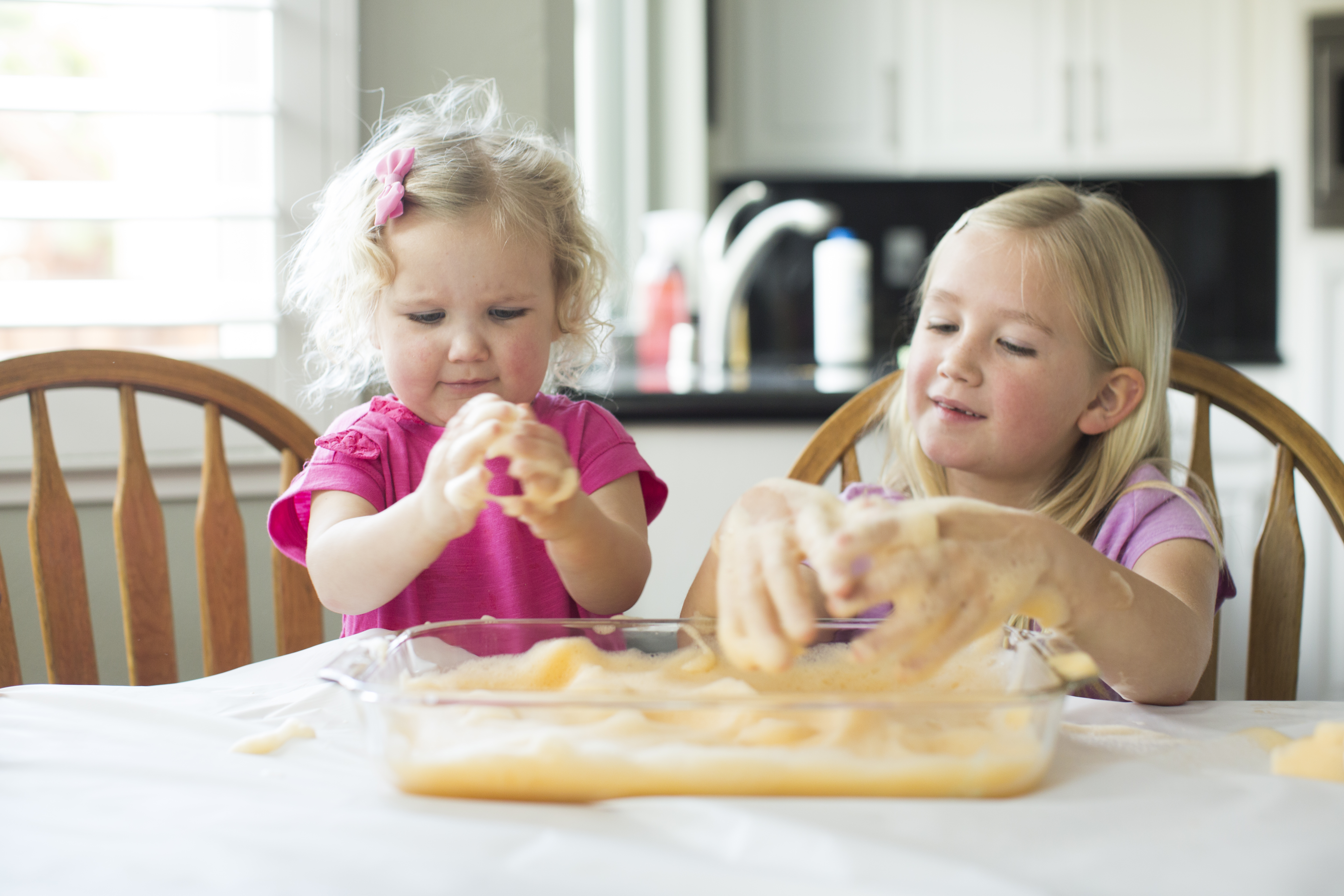 toddler and preschoolers playing whilst doing summer camp at home with mom